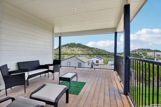 wooden terrace with an outdoor hangout area