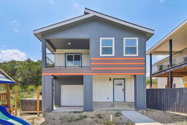 view of front of house featuring a balcony and a garage