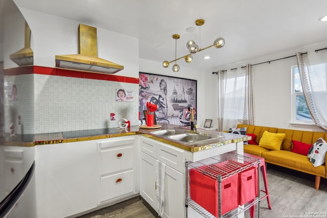 kitchen with white cabinets, backsplash, wood-type flooring, black electric cooktop, and island range hood