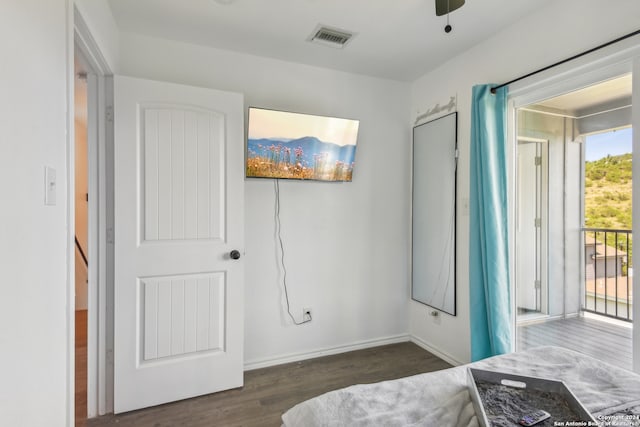 bedroom with ceiling fan, dark hardwood / wood-style floors, and multiple windows