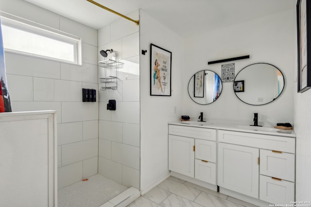 bathroom featuring tiled shower and vanity