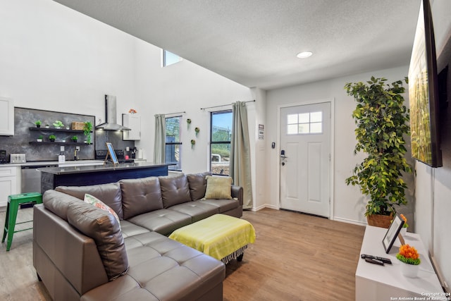 living room featuring a textured ceiling and light hardwood / wood-style floors