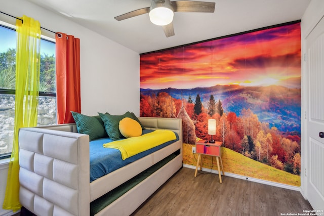 bedroom with hardwood / wood-style floors and ceiling fan