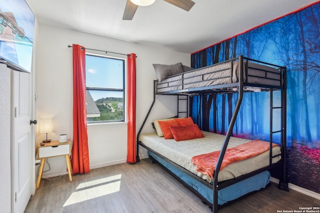 bedroom featuring hardwood / wood-style floors and ceiling fan