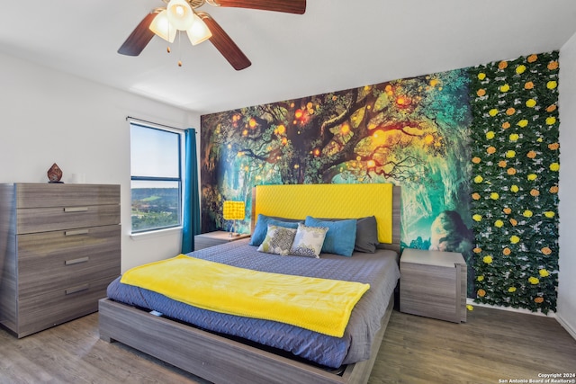 bedroom with hardwood / wood-style floors and ceiling fan