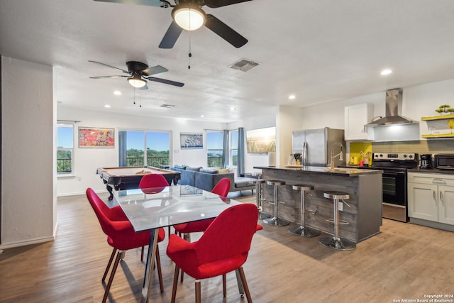 dining area with light hardwood / wood-style flooring, ceiling fan, pool table, and sink