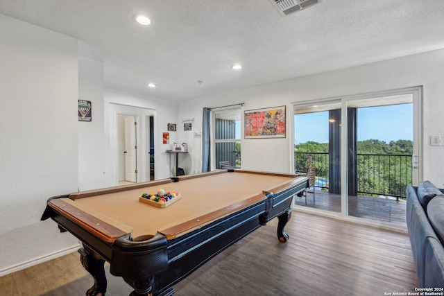 recreation room with billiards, wood-type flooring, and a textured ceiling