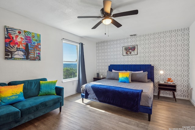 bedroom featuring a textured ceiling, hardwood / wood-style flooring, and ceiling fan