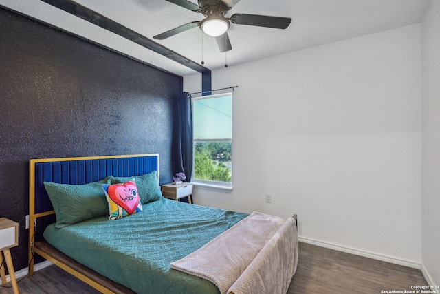 bedroom with dark hardwood / wood-style flooring and ceiling fan