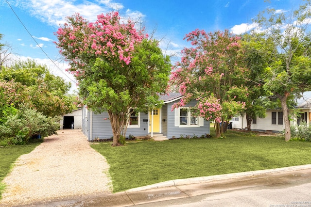 view of property hidden behind natural elements featuring a front lawn