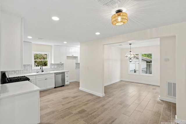 kitchen featuring decorative backsplash, white cabinets, dishwasher, sink, and range