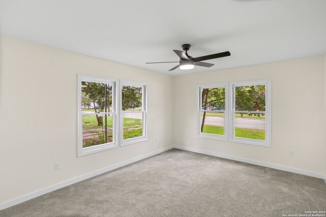 unfurnished room featuring ceiling fan and carpet flooring