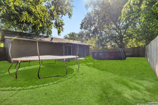 view of yard with a trampoline