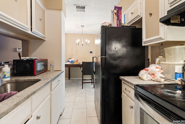 kitchen with a textured ceiling, white cabinetry, black appliances, light tile patterned flooring, and a notable chandelier