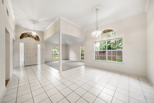 tiled entrance foyer featuring a notable chandelier and ornamental molding