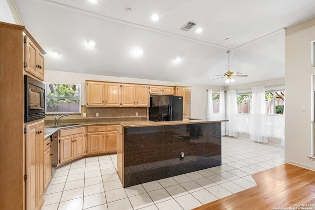 kitchen with decorative backsplash, ceiling fan, light tile patterned floors, a center island, and stainless steel appliances