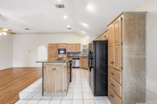 kitchen with light hardwood / wood-style flooring, light brown cabinets, ceiling fan, a kitchen island with sink, and black appliances