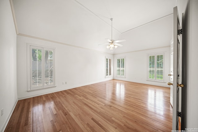 empty room featuring ceiling fan, plenty of natural light, light hardwood / wood-style floors, and ornamental molding