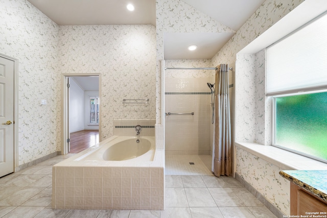 bathroom with tile patterned floors, vanity, and separate shower and tub