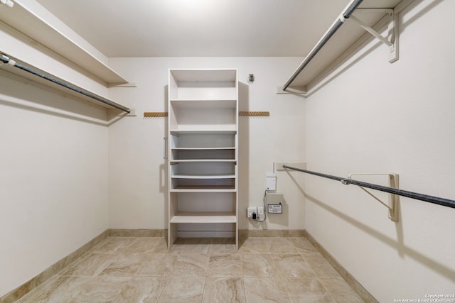 spacious closet featuring light tile patterned floors