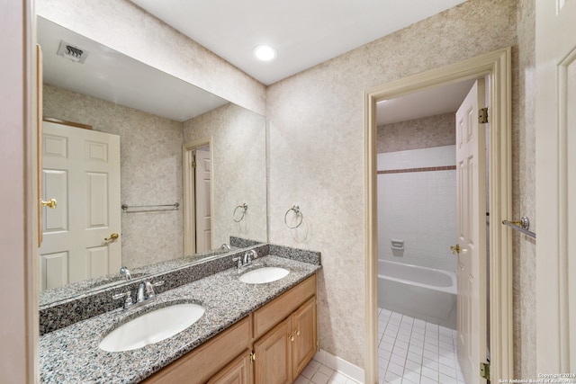 bathroom with double sink vanity, shower / washtub combination, and tile patterned flooring