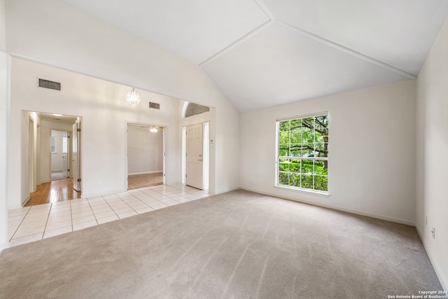 unfurnished room featuring high vaulted ceiling and light hardwood / wood-style flooring