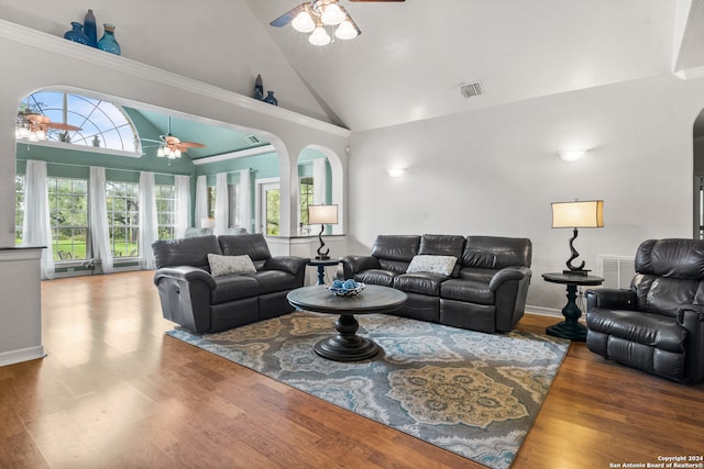 living room with hardwood / wood-style flooring, ornamental molding, ceiling fan, and high vaulted ceiling