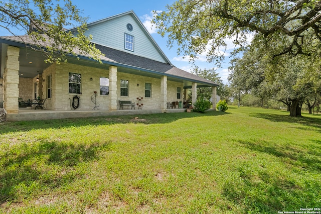 back of property with a lawn