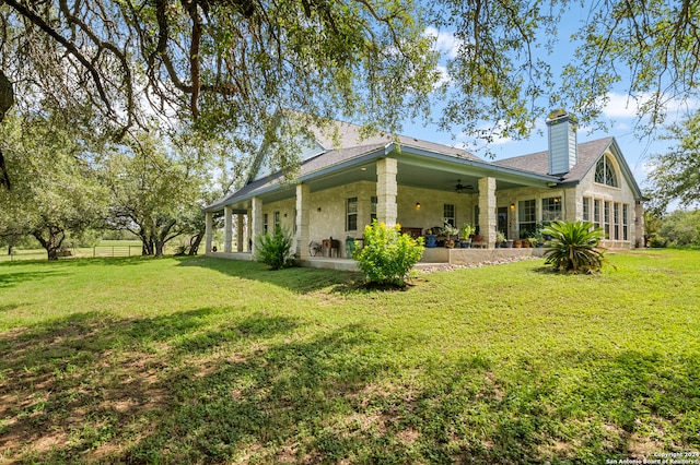 exterior space featuring ceiling fan, a patio area, and a yard