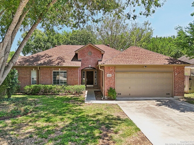 ranch-style home with a garage and a front lawn