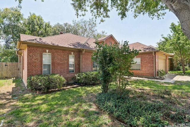 single story home featuring a garage and a front yard