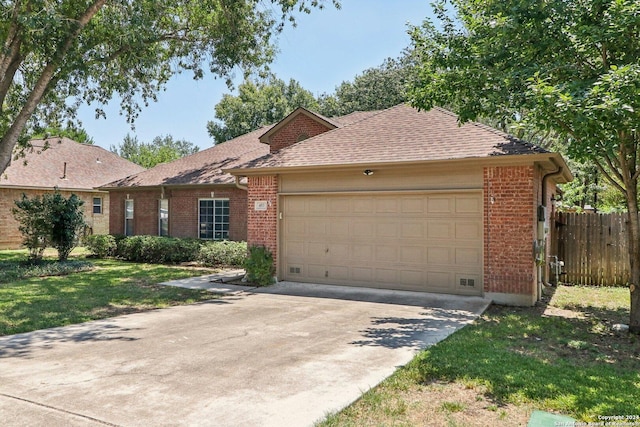 ranch-style house with a garage and a front lawn