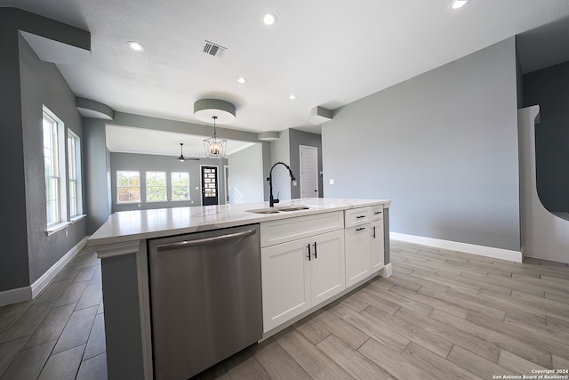 kitchen with light wood-type flooring, a kitchen island with sink, stainless steel dishwasher, white cabinetry, and sink