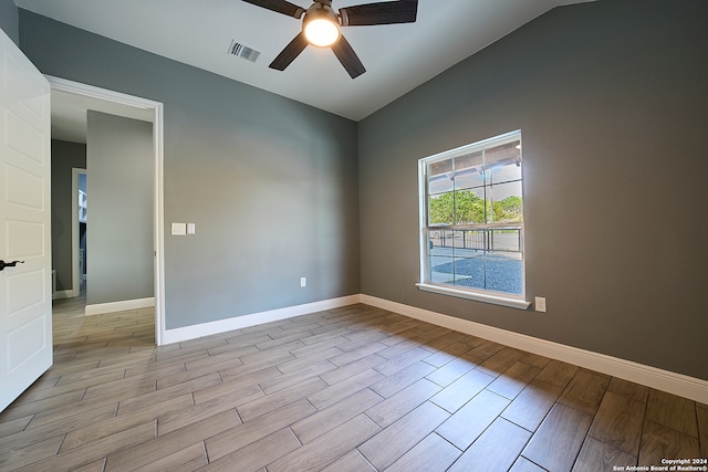 unfurnished room with ceiling fan, light wood-type flooring, and vaulted ceiling