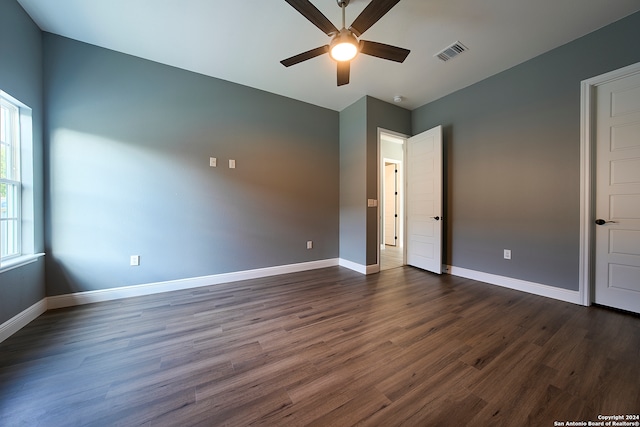 unfurnished bedroom featuring ceiling fan and dark hardwood / wood-style floors