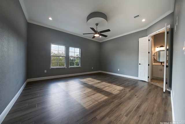 interior space with connected bathroom, dark hardwood / wood-style flooring, and ornamental molding