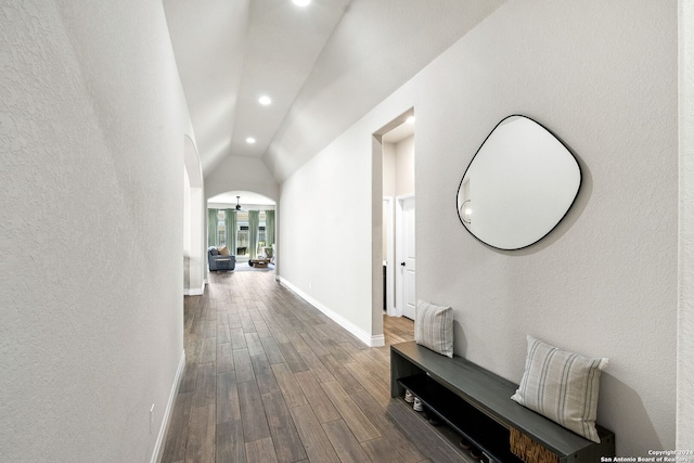 corridor with hardwood / wood-style flooring and lofted ceiling