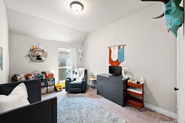 carpeted bedroom featuring lofted ceiling