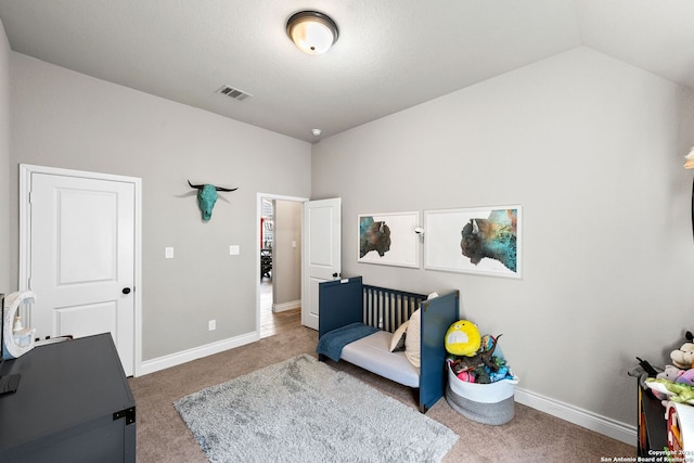 carpeted bedroom featuring lofted ceiling