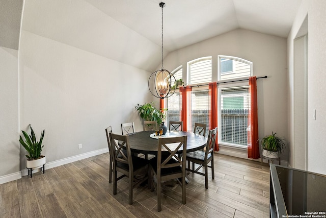 dining area with lofted ceiling, hardwood / wood-style flooring, and a chandelier