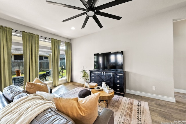 living room featuring ceiling fan and hardwood / wood-style floors