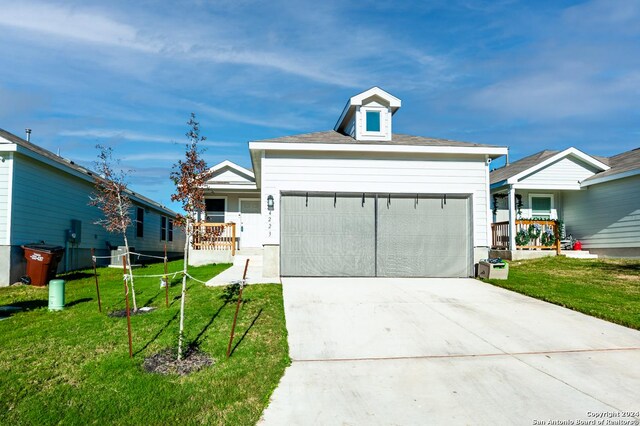 view of front of house featuring a garage and a front lawn