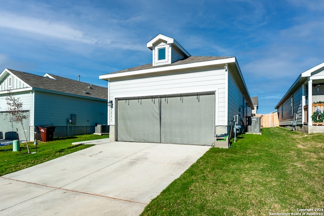 garage with central AC and a lawn