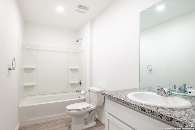 full bathroom with shower / bathtub combination, vanity, toilet, and hardwood / wood-style flooring