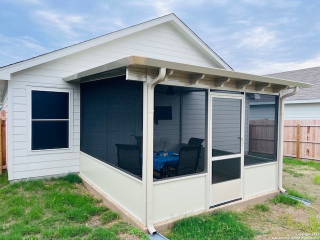 view of home's exterior with a sunroom