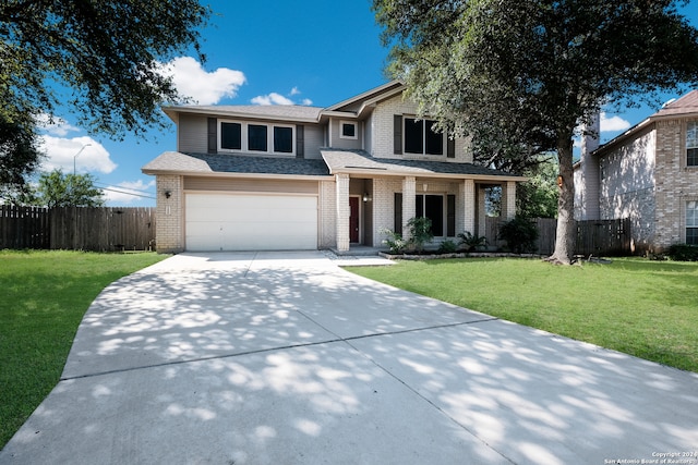 view of front of property featuring a front lawn and a garage