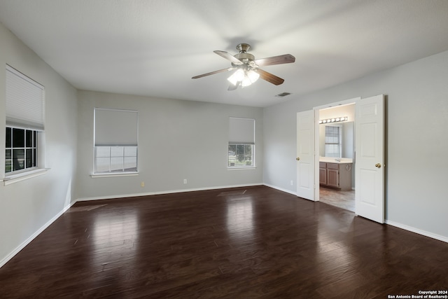 unfurnished bedroom featuring ceiling fan, wood-type flooring, and connected bathroom