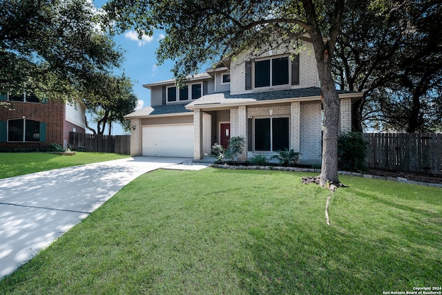 view of front facade with a front yard and a garage