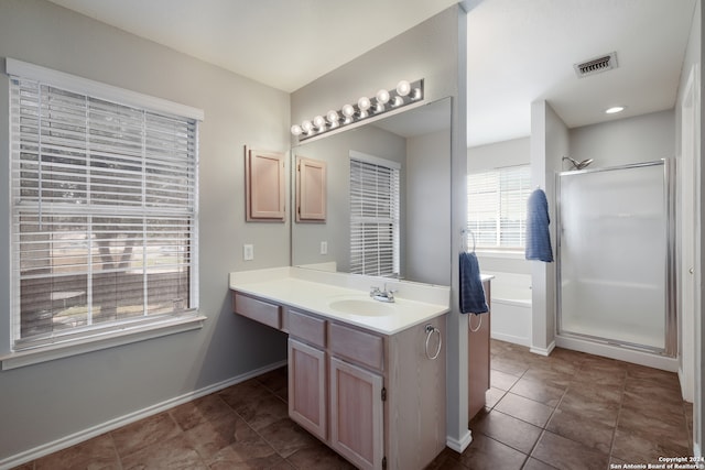 bathroom with tile patterned floors, vanity, and separate shower and tub