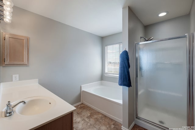 bathroom with tile patterned floors, vanity, and plus walk in shower